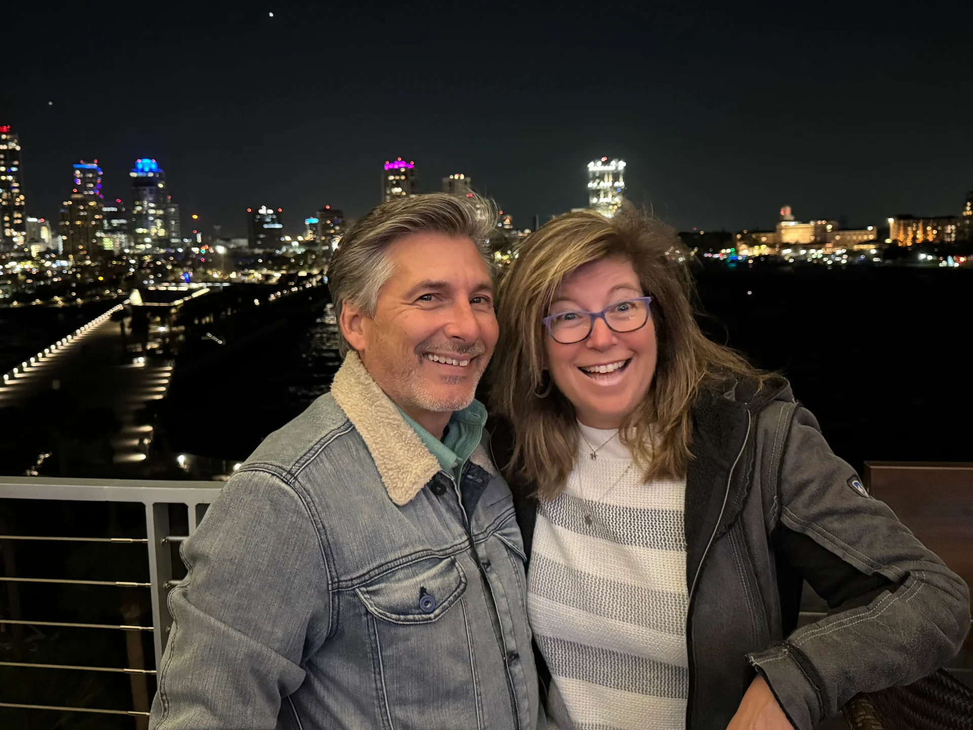 Deana Rock and Al Levy, co-founders of RevRocket, with a city skyline at night